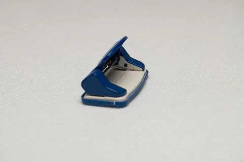 Blue stapler on white surface Stock Photos