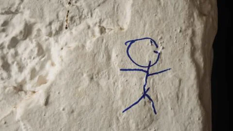 Blue stick figure drawn on bumpy wall Stock Photos