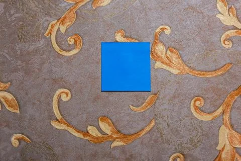 Blue sticky note centered on a decorative fabric background with ornate Stock Photos