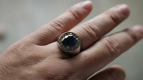 Blue stone silver ring on finger, close up Stock Footage 231733920