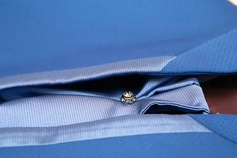 Blue suit jacket with silk lining folded showing detailing and button 스톡 사진
