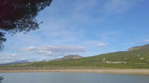 Blue Summer Sky With Clouds Above Terradets Lake and Mountains Stock Footage 335331546