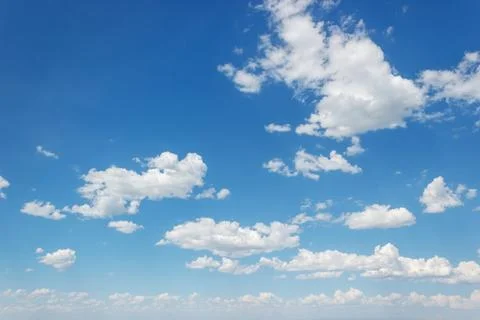 Blue summer sky with curly clouds stretching to the horizon Stock Photos