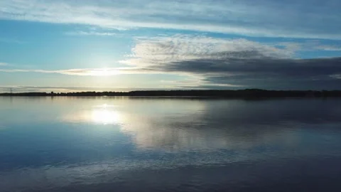 Blue sunrise sky and reflection on river Stock Footage 130863876