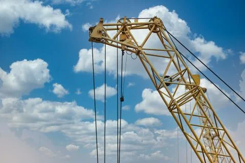 Blue sunset sky after five big high cranes under a new construction site of h Stock Photos