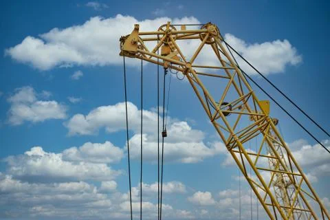 Blue sunset sky after five big high cranes under a new construction site of h Фото