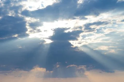 Blue sunset sky background and sun rays coming out. Natural background Stock Photos