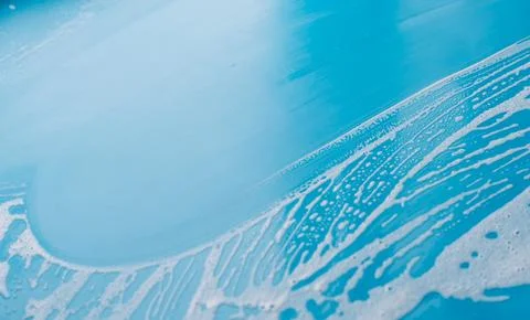 Blue surface with a broad wiped area and diagonal foam edge Stock Photos