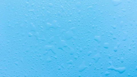 Blue surface with droplets and splashes of clear water. Stock Footage 90424785