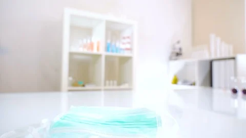 The blue surgical mask on the white table Stock Footage 127781228
