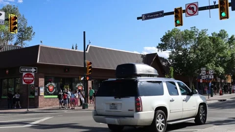 Blue SUV and white vehicle drive through an intersection in Park City. Stock Footage 345548236