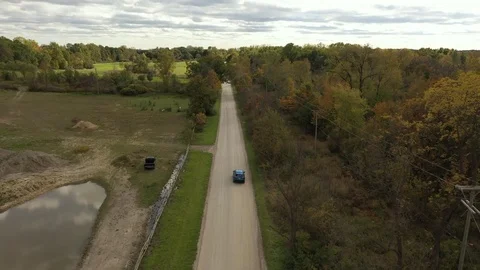 Blue SUV Driving on a Dirt Road Stock Footage 118090964