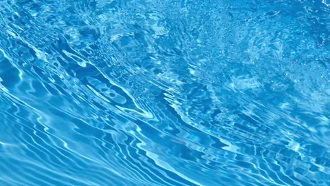 Blue swimming pool water surface with moving ripples, waves, reflections, and Stockbeeldmateriaal 343424918
