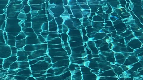 Blue swimming pool water surface showing bright sunlight reflections. Stock Footage 344320718