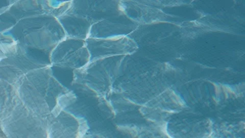 Blue Swimming Pool Water Surface with Sunlight Caustics and Ripples Stock Footage 344436237