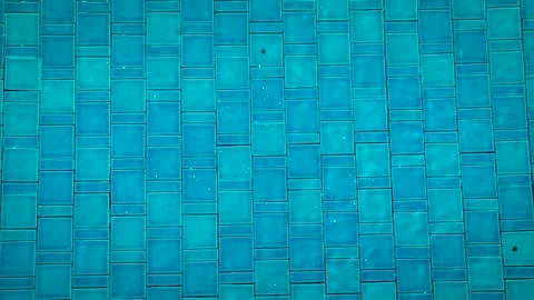 Blue swimming pool water texture with tile pattern top view background 動画素材 332791123