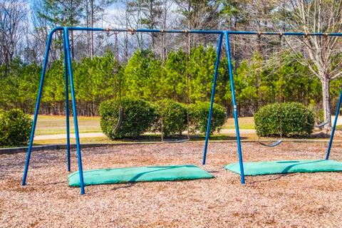 A blue swing set in a park Fotos Stock