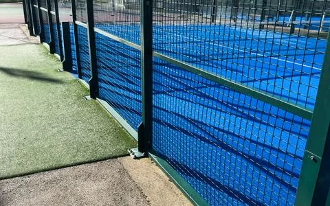 The blue synthetic grass surface of a paddle tennis court, near the net 写真素材