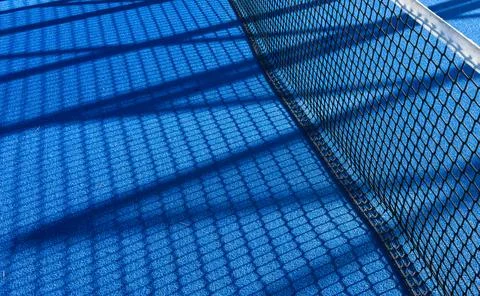 The blue synthetic grass surface of a paddle tennis court, near the net 写真素材