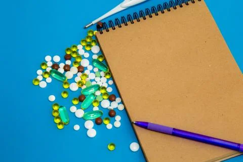 On a blue table is a notebook of their natural material for recording, and ne Stock Photos