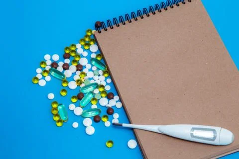 On a blue table is a notebook of their natural material for recording, and ne Stock Photos