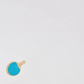 A blue table tennis racket in the lower left on a white background with cop.. Foto stock
