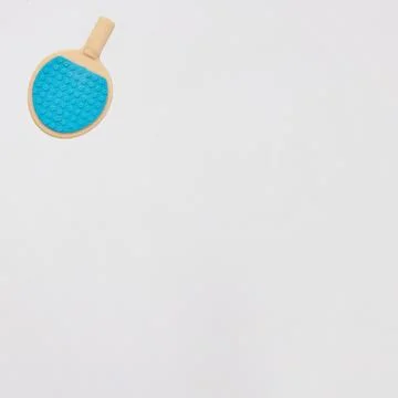 A blue table tennis racket in the upper left on a white background with cop.. Stock Photos
