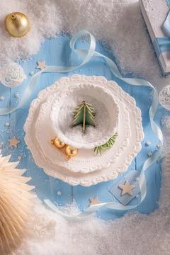 Blue table theme featuring snowy Christmas decor. Stock Photos