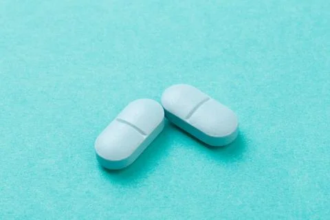 Blue tablets  on blue  background - Image Stock Photos