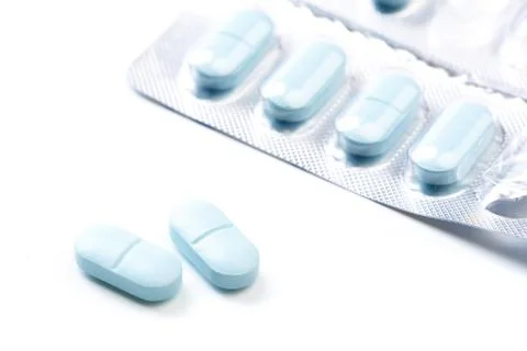 Blue tablets isolated on white background - Image Stock Photos