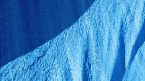 Blue tarp slowiy blowing in the wind Stock Footage 103394295