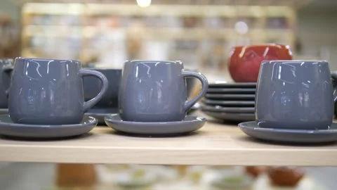 Blue tea cups or mugs with saucers, plates standing on a shelf. Tea set or Stock Footage 313046248
