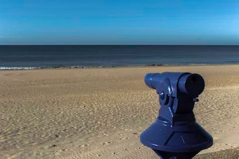 Blue telescope with the beach in the background Stock Photos