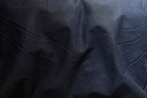 Blue textile background with shadows and folds of fabric for design and backi Stock Photos