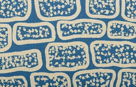 Blue textile fabric with abstract pattern of beige organic shapes and scattered Illustrazione stock