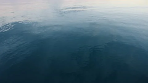 Blue texture water surface small waves slow motion move form ripples at sunset Stock Footage 263422568