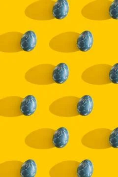Blue textured colored Easter eggs on a bright yellow holiday background backdrop Stock-Fotos