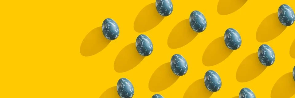 Blue textured colored Easter eggs on bright yellow holiday background backdrop Stock Photos