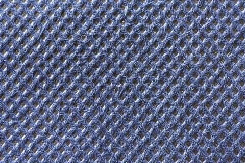 A blue textured material with a repeating diamond pattern. Stock Photos