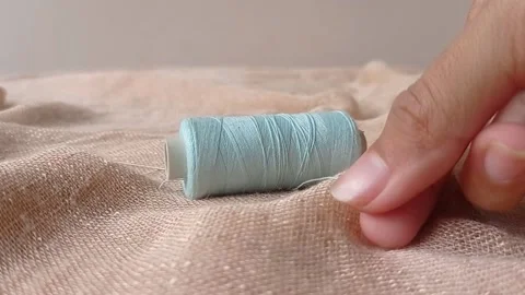 A blue thread on a brown clothe Stock Footage 146248626