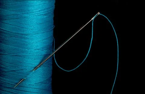 Blue thread with needle Stock Photos