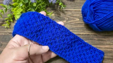 A blue thread pattern on a wooden background. Knitting tutorial and sample of Stock Photos