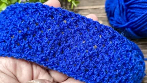 A blue thread pattern on a wooden background. Knitting tutorial and sample of Stock Photos