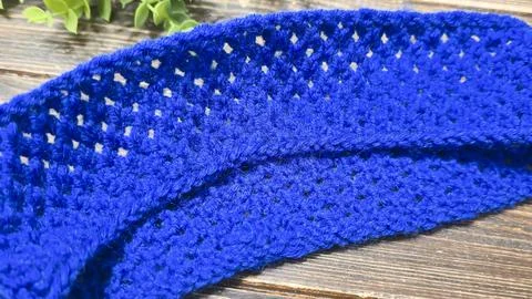 A blue thread pattern on a wooden background. Knitting tutorial and sample of Stock Photos