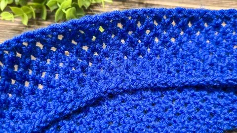 A blue thread pattern on a wooden background. Knitting tutorial and sample of Stock Photos