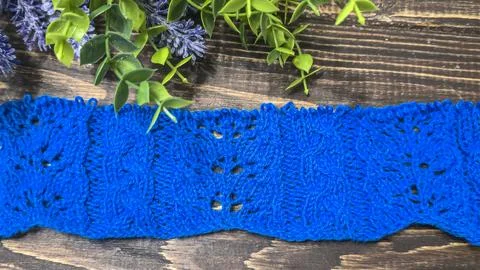 A blue thread pattern on a wooden background. Knitting tutorial and sample of Stock Photos