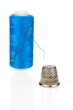 Blue Thread Spool with Needle and Silver Thimble Close-up Isolated Stock Photos