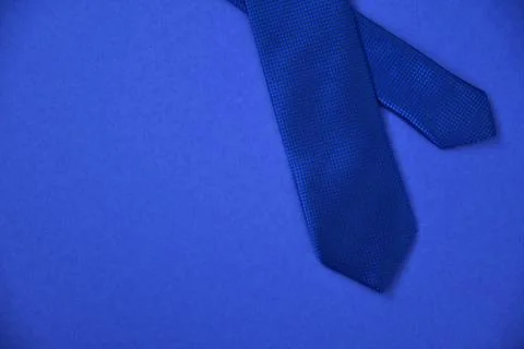 Blue tie on a blue background Stock Photos
