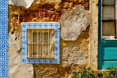 Blue tile adorns a window set in very old stone in Lisbon, Portugal Stock Photos