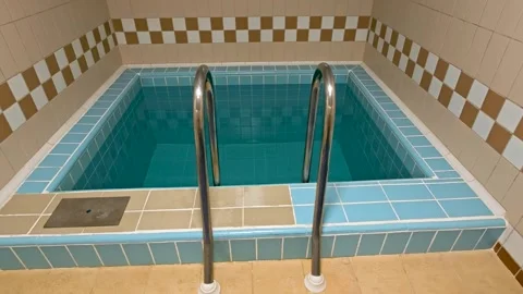 A blue tiled bath tub in a tiled bathroom Stock Footage 345987679
